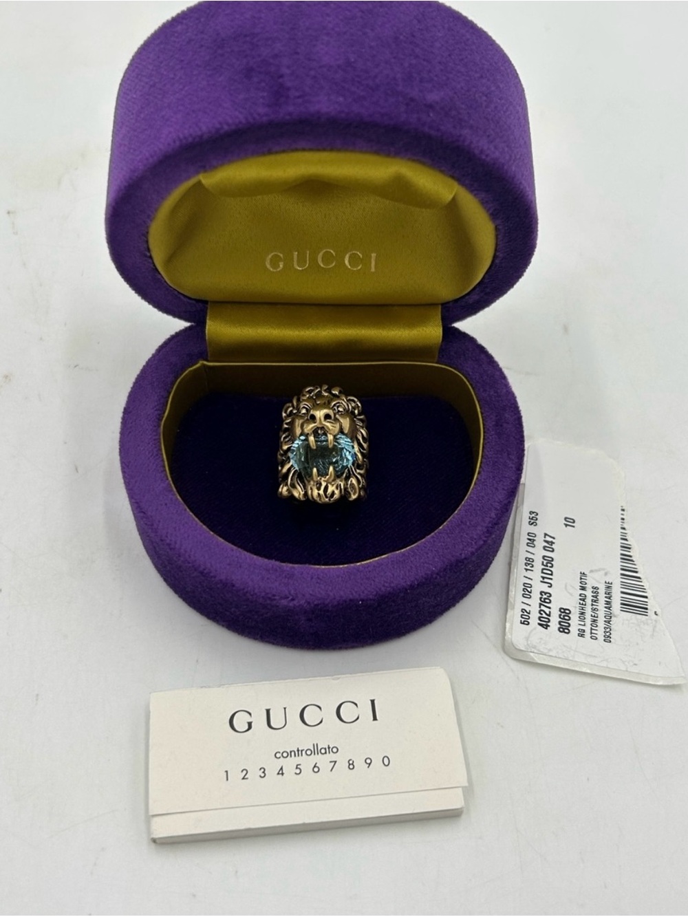 Unisex, Gucci, Lionhead, gold tone metal ring with prominent blue crystal size 5
